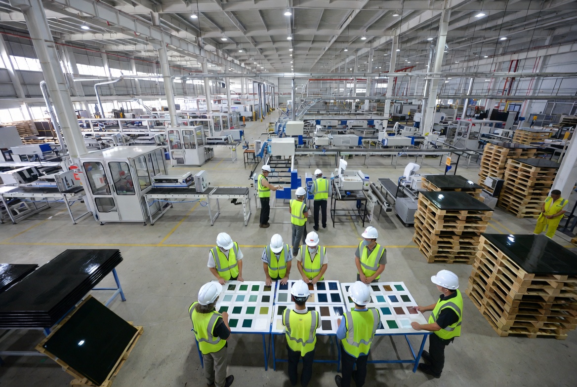 Factory Exterior With Inspection Team